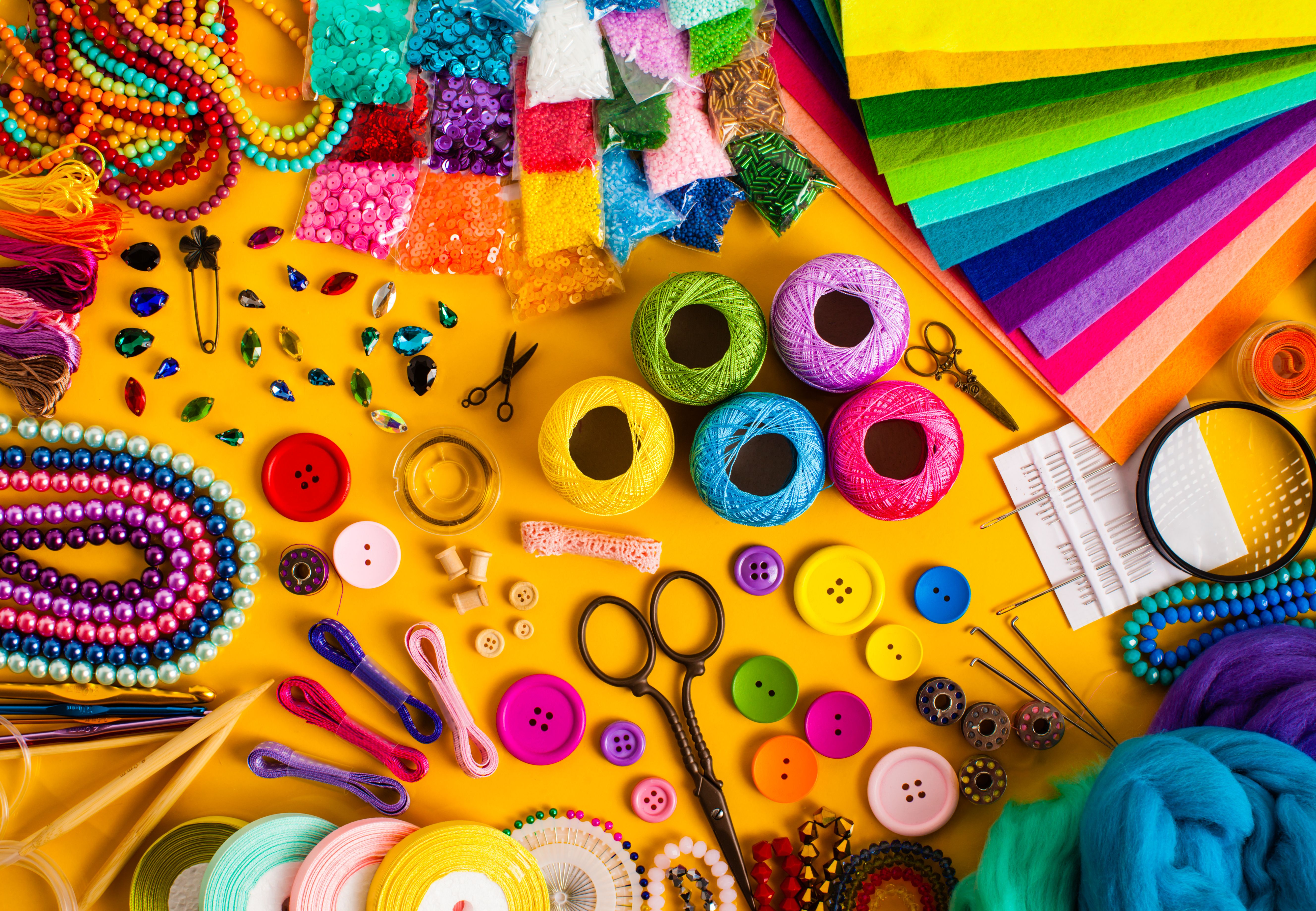 Craft materials for DIY projects: thread, buttons, felt & beads for creative T-shirt design and textile upcycling.