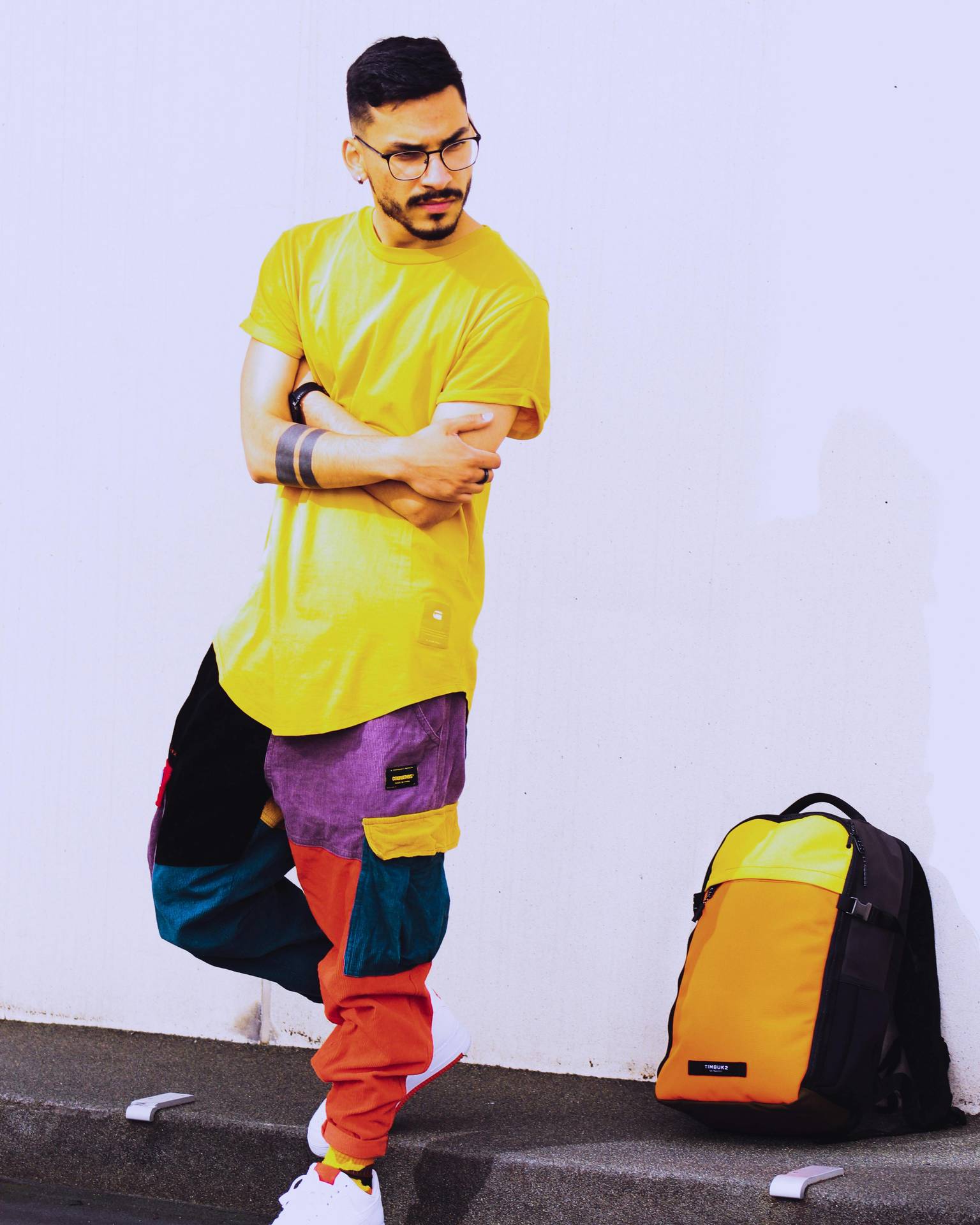 Young man with yellow T-shirt and colorful pants