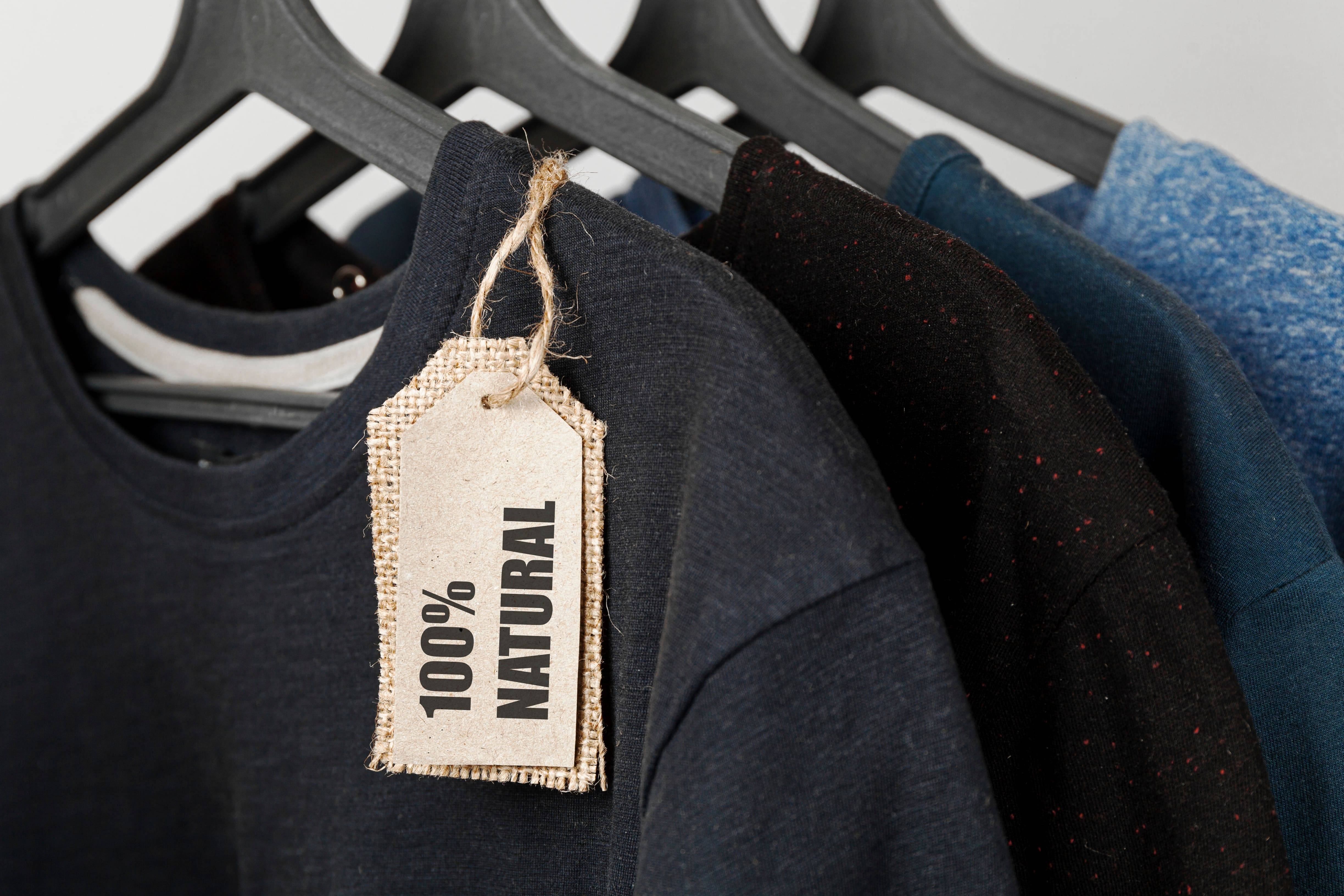 Clothing made from 100% natural materials – bio T-shirts on hangers with sustainability tags