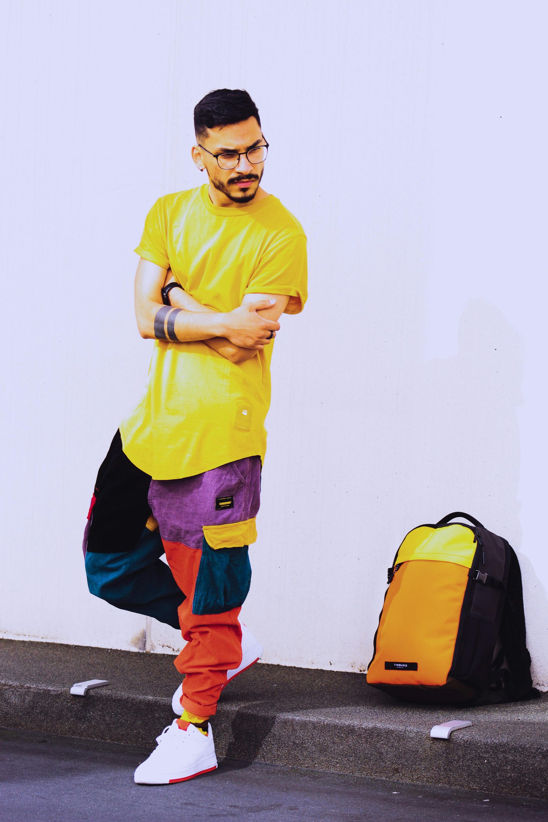 Junger Mann mit gelbem T-Shirt und bunter Hose Junger Mann mit gelbem T-Shirt und bunter Hose